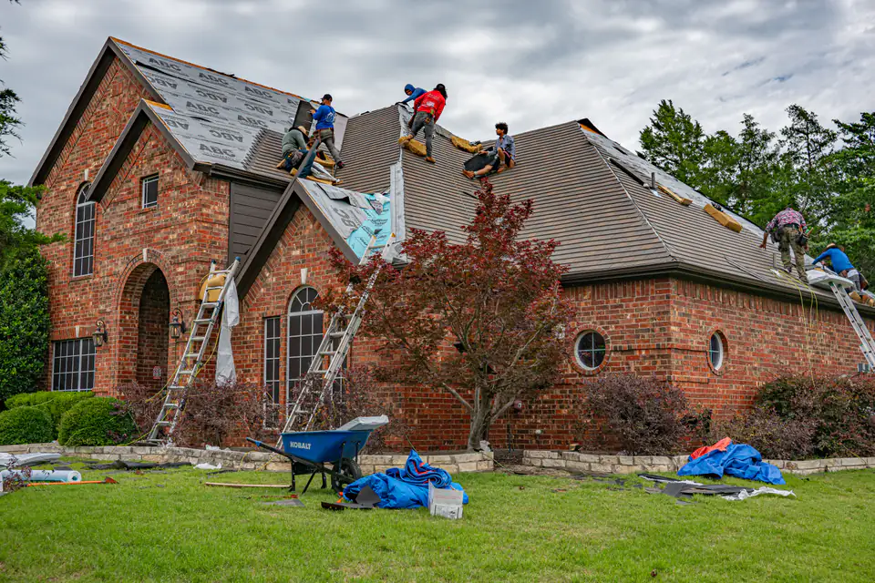 Residential roofing crew working on a brick home
